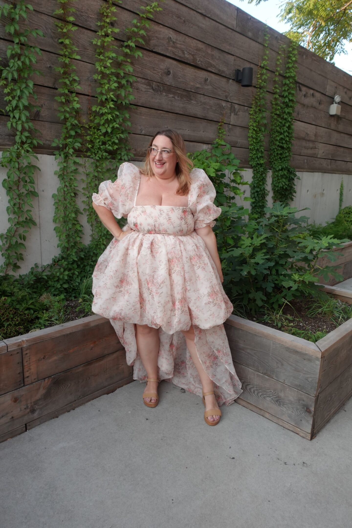 plus size woman in a high low floral printed dress