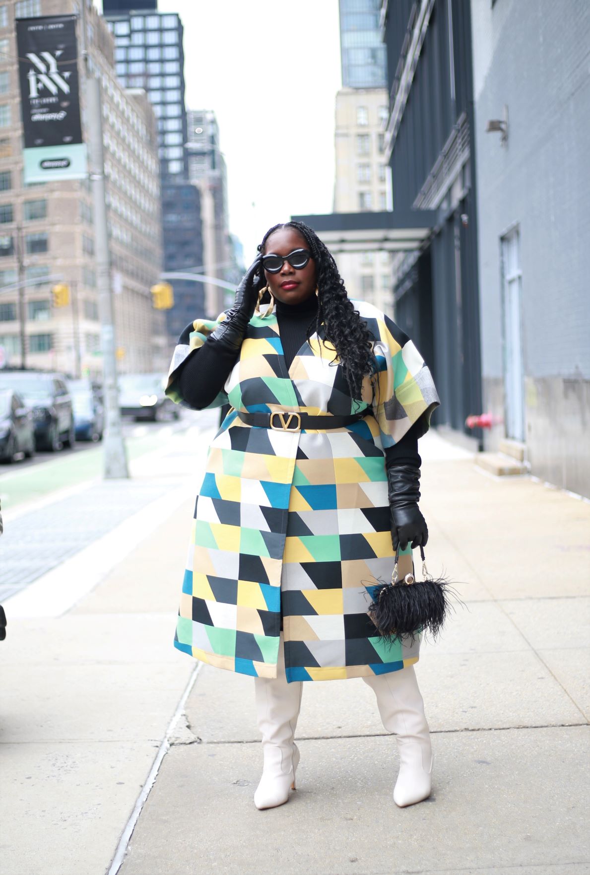 New York Fashion Week cold weather Outfits featuring plus size blogger Stylish curves in a colorful checkered coat with white boots and black leather gloves, black sunglasses, and a feather bag
